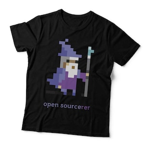 May include: A black short-sleeved t-shirt featuring a pixel art graphic of a wizard wearing a purple robe and hat, holding a staff. Below the graphic, the text "open sourcerer" is printed in a light purple, sans-serif font on the chest area.