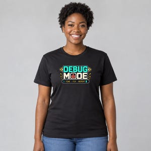 Young woman wearing the black Software Developer Debugging graphic T-shirt, front mid-length view
