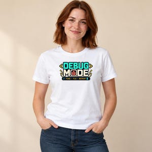 Young woman wearing the white Software Developer Debugging graphic T-shirt, front mid-length view