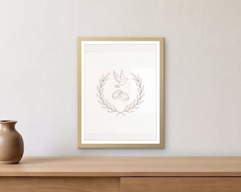 May include: A framed wall art piece featuring a gold frame and a white print. The print displays a dark gray line drawing of two interlocking rings centered within a circular laurel wreath, with a small bird flying above the rings.