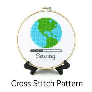 May include: A cross stitch pattern of a blue and green globe with a progress bar that reads "Saving".
