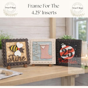 May include: Three decorative wooden inserts, each 4.25 inches square, displayed on small easels. One features a bee and the word "June", another has pink rain boots and the word "April", and the last shows a Christmas ornament and "December 25".