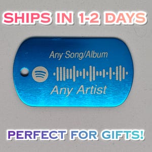 May include: A rectangular blue metal dog tag with rounded corners and a small hole on the left side. The tag features an engraved Spotify logo, a sound wave graphic, and the text Any Song/Album and Any Artist etched into the surface.