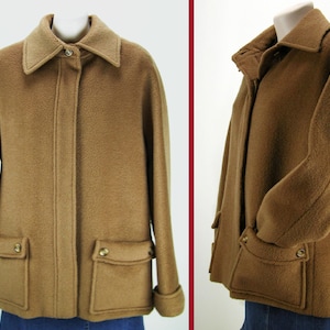 May include: A brown wool jacket with a zipper closure, two large pockets, and a collar. The jacket has a slightly fitted silhouette.