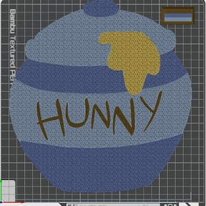 May include: A blue honey pot design with a lid, featuring a yellow honey drip graphic and the word HUNNY written in brown letters. The design is displayed on a dark gray grid background with a small rectangular color swatch in the top right corner.