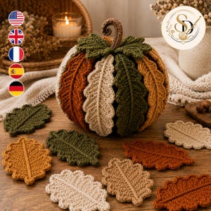 Woodland crochet pumpkin made from textured leaf coasters in olive, cream, rust and camel, with matching leaf coasters displayed around it and language flags at left.