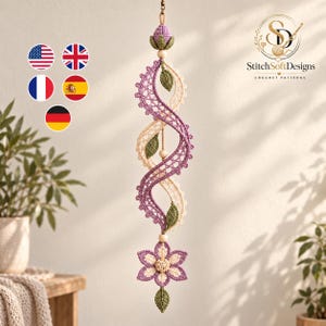 May include: A hanging crochet decoration featuring a spiraling design in lavender and cream yarn. The piece is accented with small green crocheted leaves and wooden beads, topped with a lavender bud and finished with a six-petaled flower.