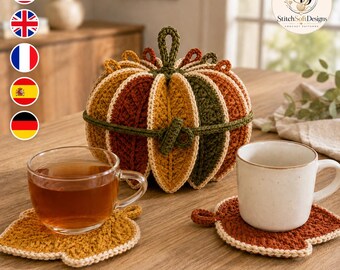 May include: A crochet pumpkin-shaped holder tied with a green cord, accompanied by two leaf-shaped crochet coasters in mustard yellow and rust orange. A clear glass teacup filled with tea and a white ceramic mug sit on the coasters.