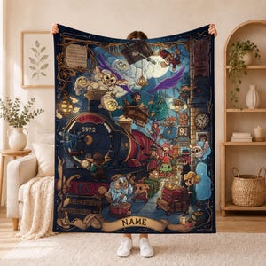 May include: A dark blue fleece blanket featuring a detailed fantasy illustration of a steam train labeled Express 5972, various magical creatures, a clock, and a banner at the bottom with the word NAME in bold, capitalized, gold-toned lettering.