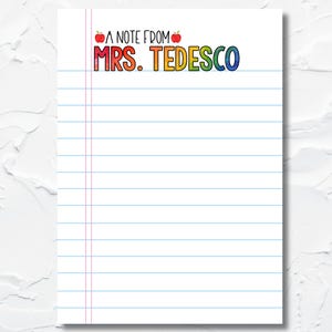 May include: White notepad with blue horizontal lines and a red vertical line on the left side. The notepad has the text "A NOTE FROM MRS. TEDESCO" in colorful letters and two red apple illustrations. The top of the notepad reads "PREMIUM NOTEPADS".