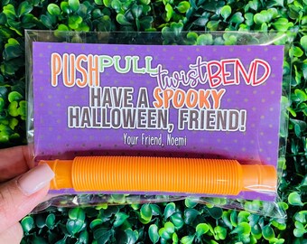 May include: Orange plastic toy that says "Push Pull Twist Bend Have a Spooky Halloween, Friend!"  Your Friend, Noemi