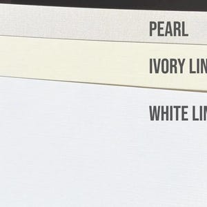 May include: Three rectangular paper samples stacked vertically. The top sheet is labeled PEARL, the middle sheet is labeled IVORY LINEN, and the bottom sheet is labeled WHITE LINEN. Each sheet displays a distinct color and a subtle, fine-textured surface.