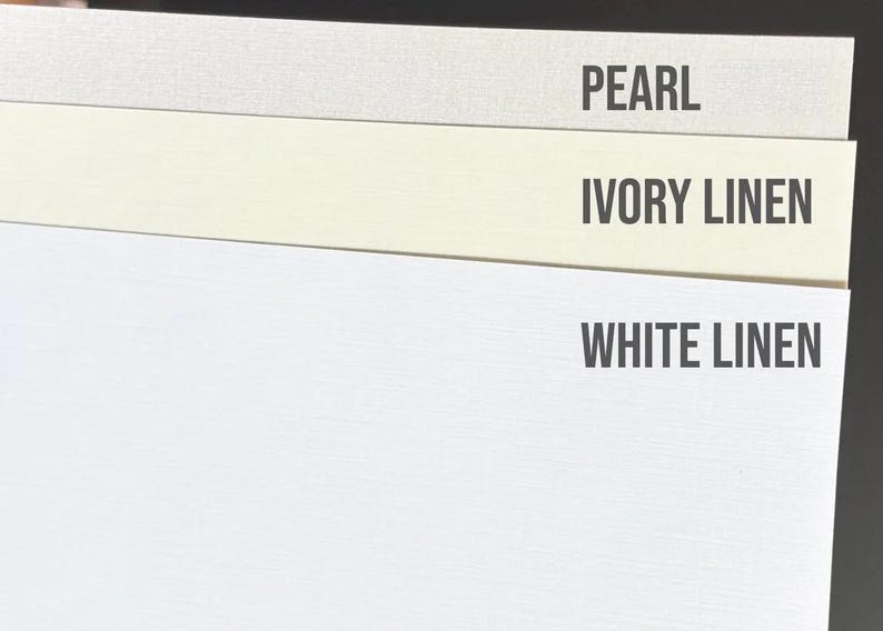 May include: Three rectangular paper samples stacked vertically. The top sheet is labeled PEARL, the middle sheet is labeled IVORY LINEN, and the bottom sheet is labeled WHITE LINEN. Each sheet displays a distinct color and a subtle, fine-textured surface.