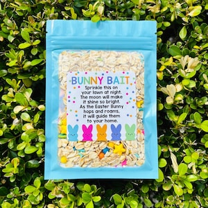 May include: A light blue, resealable bag filled with oats and colorful sprinkles, labeled "BUNNY BAIT." The text encourages sprinkling the contents on the lawn at night to attract the Easter Bunny. The label features cartoon bunny illustrations.