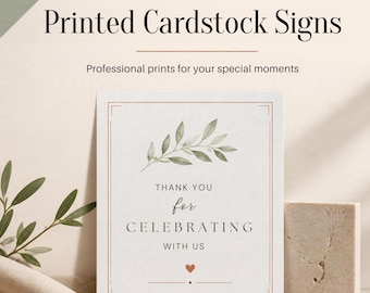May include: A rectangular cardstock sign featuring the text Printed Cardstock Signs and Professional prints for your special moments. The sign displays a watercolor olive branch, the text THANK YOU for CELEBRATING WITH US, and a small red heart.