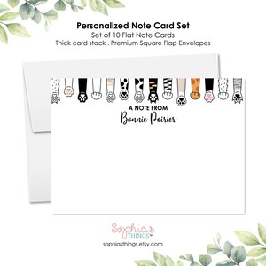 May include: A set of 10 personalized note cards with a border of paw prints. The cards are white with black text that reads "A note from Bonnie Poirier".