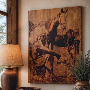 May include: A rectangular wooden wall art piece featuring a dark brown, high-contrast illustration of a person sitting beside a horse. The artwork displays natural wood grain textures and deep brown tones, mounted on a wall above a wooden surface.