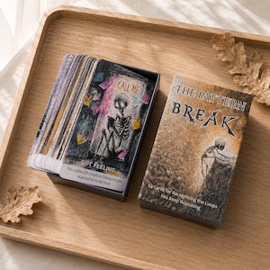 May include: A deck of 54 cards titled The Pattern Break, featuring a box with a skeleton illustration and a card showing a skeleton with the text Call Me and Gut Feeling. The cards are in a dark box, with text reading 54 Cards for Recognizing the Loops You Keep Repeating.