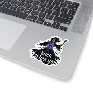 May include: A die-cut sticker featuring a dark-haired sorceress in a flowing black robe holding a staff and casting a glowing purple magical orb. The text "bitch I'll hex you" is printed in a bold, gothic-style white font across the bottom section.