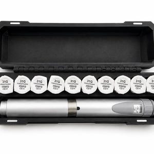 May include: A black rectangular storage case containing a silver cylindrical pen-style device and nine white circular needle caps. Each cap is labeled with 31G, 0.25mm, and CE 0197. The device features a small digital display window on one end.