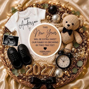 May include: A white baby bodysuit with the text Baby Anderson, a pair of black shoes, a crochet teddy bear with a black bow tie, a round wooden sign reading This New Year Will Be Extra Sweet, a sonogram, and gold 2027 balloons in a basket.