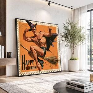 May include: A rectangular wall art print featuring a vintage-style illustration of a muscular figure wearing a pointed hat and black shorts, riding a broomstick against an orange background with the text Happy Halloween in black lettering.