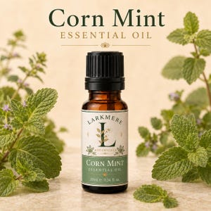 May include: A small amber glass bottle of Larkmere Botanicals Corn Mint essential oil with a black cap. The label features a large letter L, floral illustrations, and the text Corn Mint Essential Oil 10ml e 0.34 fl. oz.
