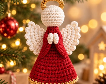 May include: A crocheted angel ornament featuring a cream-colored head and wings, a red dress, and a gold halo and hem. The figure has hands clasped in front and a small loop at the top for hanging, crafted with detailed yarn stitching throughout.