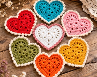 May include: A collection of seven heart-shaped crochet coasters in various colors including red, teal, pink, white, olive green, orange, and yellow. Each coaster features a central floral pattern and a scalloped cream-colored border edge.