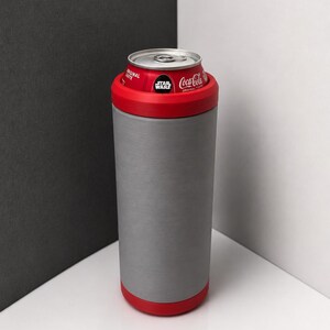 May include: A cylindrical gray beverage cooler with a red rim at the top and bottom. A Coca-Cola can with a Star Wars logo is inserted into the cooler. The cooler has a smooth, matte finish and a tall, slender design that holds the soda can securely.