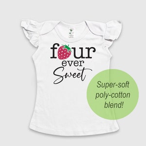 May include: White short-sleeved shirt with a ruffle trim on the sleeves. The shirt has a strawberry graphic and the text "four ever sweet" printed on the front. The shirt is made of a super-soft poly-cotton blend.