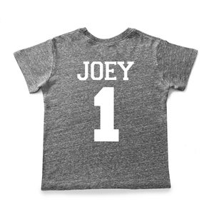 May include: A gray heather t-shirt with white text that says "JOEY 1" on the back.