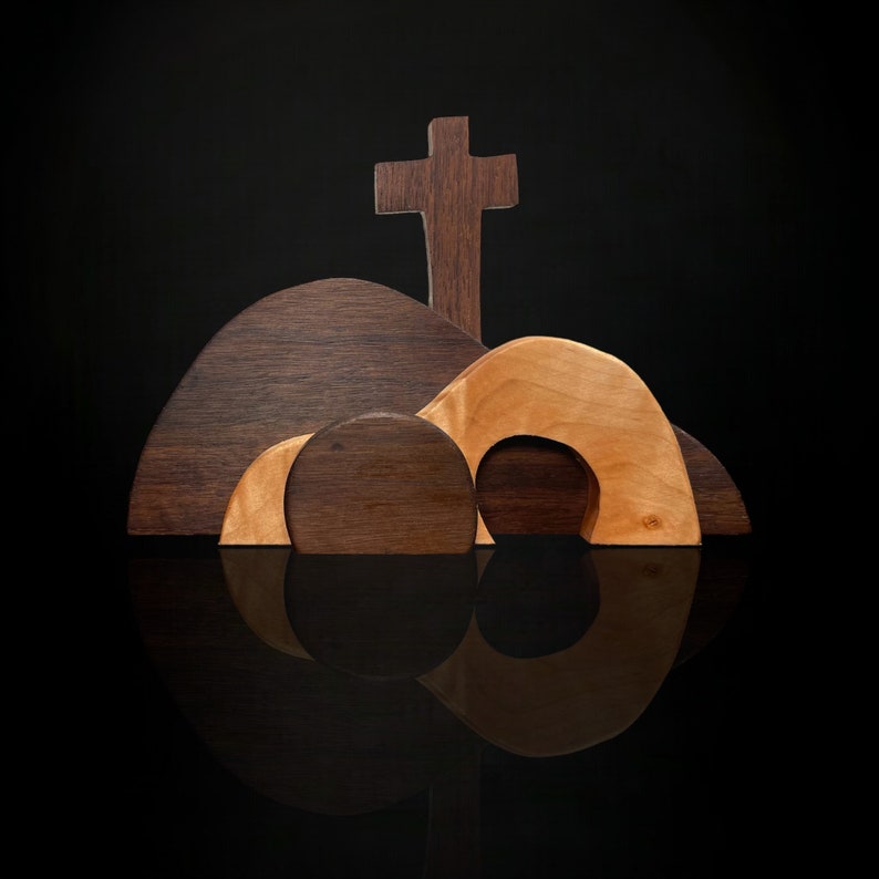 May include: Wooden Easter tomb set with a brown cross, three brown and beige tombs, and a reflection on a black surface.