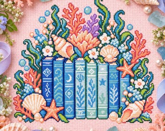 Può includere: Un motivo a punto croce su tessuto rosa che raffigura una fila di libri blu circondati da coralli colorati, conchiglie, stelle marine e piccoli fiori bianchi. I libri sono decorati con varie icone marine tra cui una luna e delle stelle.