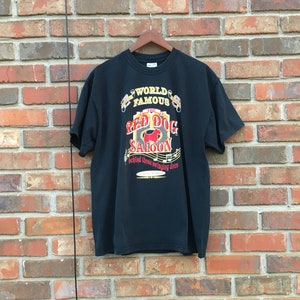Vintage des années 90 Red Dog Saloon derrière ces portes battantes Juneau Alaska T-shirt à manches courtes taille XL