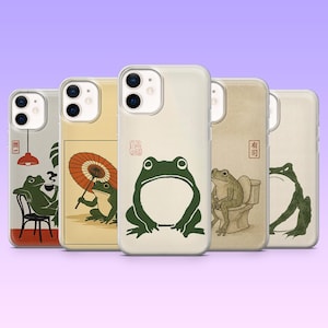May include: Five clear smartphone cases featuring various illustrations of green frogs. Designs include a frog drinking coffee, holding an umbrella, sitting on a toilet, and two other frog poses. Each case displays unique red kanji text stamps.