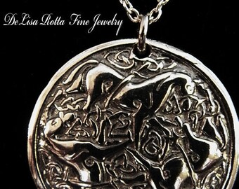 May include: A silver pendant necklace with a detailed Celtic knot design. The pendant is round and features intricate knotwork.