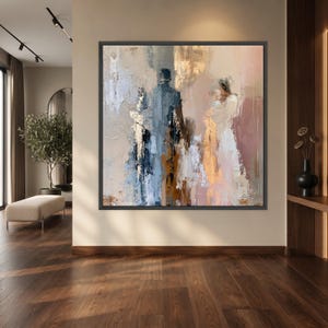 Könnte beinhalten: Ein quadratisches, gerahmtes Ölgemälde mit einer abstrakten Darstellung einer Familiengruppe. Die Komposition verwendet eine Palette aus sanftem Beige, gedämpftem Blau, warmem Gold und Weiß mit dicken Pinselstrichen und Texturen.