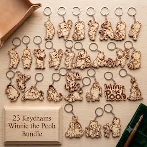 May include: A collection of 23 wooden keychains featuring laser-engraved Winnie the Pooh characters, including Pooh, Tigger, Piglet, Eeyore, and Owl. The set includes a wooden display box with the text 23 Keychains Winnie the Pooh Bundle.