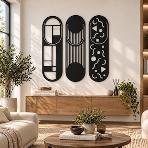 May include: Three vertical, matte black wall art panels with rounded ends. The left panel features a geometric grid, the center panel displays vertical lines and a solid semi-circle, and the right panel contains scattered shapes including circles, triangles, and squiggles.