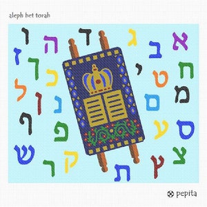 May include: A needlepoint canvas featuring a central Torah scroll with a crown and tablets design in blue, gold, and green. The background is light blue, surrounded by colorful Hebrew alphabet letters. Text reads aleph bet torah and pepita.