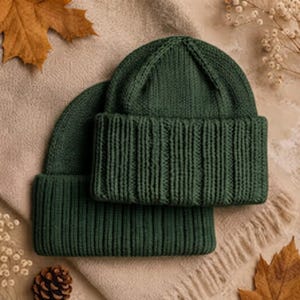 May include: Two dark forest green knit beanies featuring a thick ribbed texture and a wide folded cuff. The hats are constructed with a vertical knit pattern that extends from the crown down to the bottom edge of the brim, creating a uniform look.