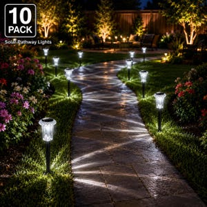 May include: A 10-pack of solar pathway lights featuring clear, textured glass tops and black stakes. These outdoor lights are installed along a stone walkway, casting bright, patterned white light beams across the path and surrounding grass.