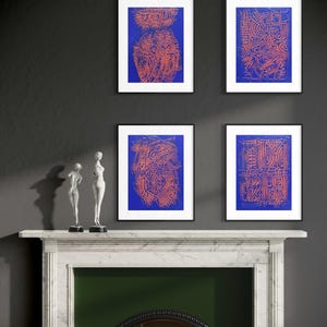 May include: Four framed rectangular wall art prints featuring intricate orange line patterns on a solid blue background. The prints are arranged in a two-by-two grid, each encased in a thin black frame, displaying abstract geometric and organic shapes.