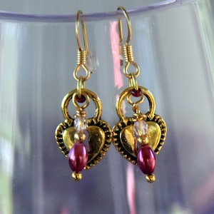 Rice Pearl Lockets-  Antiqued Gold Heart shaped Lockets w/dyed Rice pearls & pale pink Crystals.