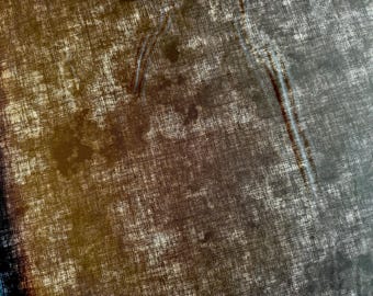 May include: A close-up of a textured fabric with a brown and gray color scheme. The fabric has a woven appearance with a subtle pattern.