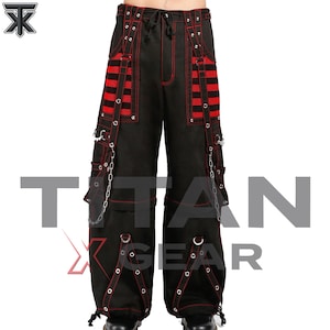 May include: Black cargo pants featuring red contrast stitching, red mesh paneling on the thighs, silver-toned metal eyelets, decorative straps, and hanging silver chains. The pants have a drawstring waist and adjustable leg openings with toggles.