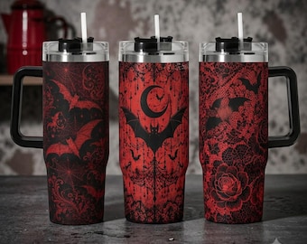 May include: Three tall stainless steel tumblers with handles and straws. The tumblers feature black and red patterns including bats, spiderwebs, crescent moons, and floral lace designs. Each tumbler has a clear lid and a white straw inserted.