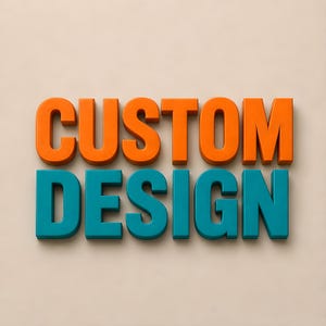May include: Three-dimensional block letters spelling the words CUSTOM DESIGN. The word CUSTOM is in bright orange, and the word DESIGN is in teal. The letters have a clean, sans-serif font style and are arranged in two rows against a neutral background.