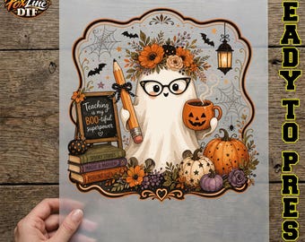 May include: A DTF transfer sheet featuring a ghost wearing glasses and a floral crown, holding a pencil and a pumpkin mug. A chalkboard reads Teaching is my BOO-tiful superpower, with stacked books, pumpkins, bats, and spiderwebs in the design.